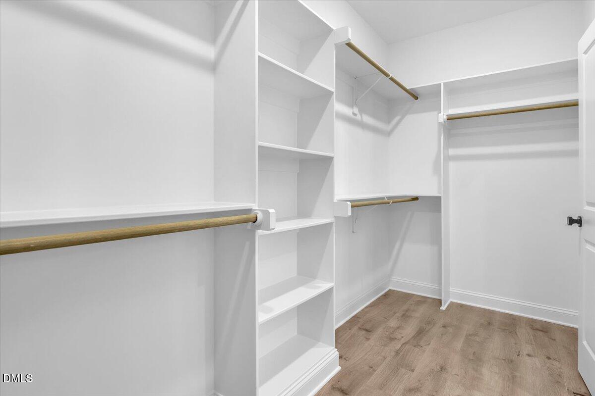 12845 Mallard Rock Road Zebulon, NC 27597 - Photo 46 of 63 a view of walk in closet with empty racks