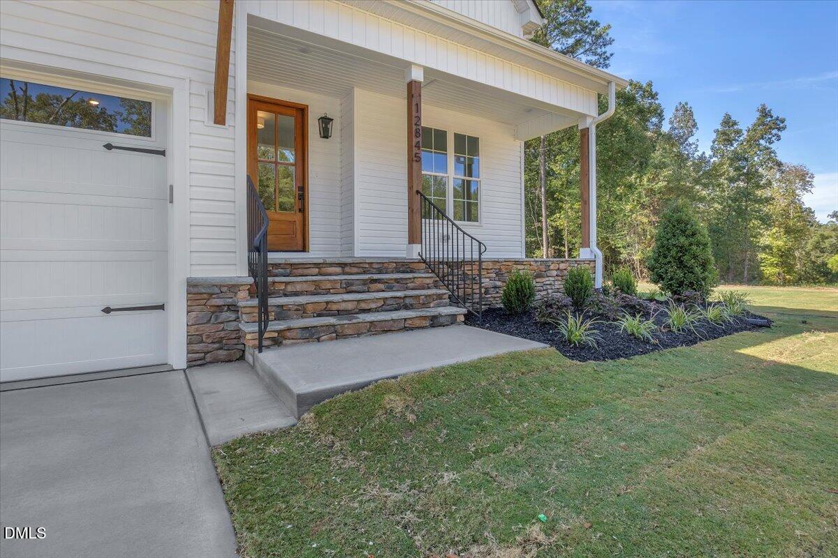 12845 Mallard Rock Road Zebulon, NC 27597 - Photo 5 of 63 front view of a house with a yard