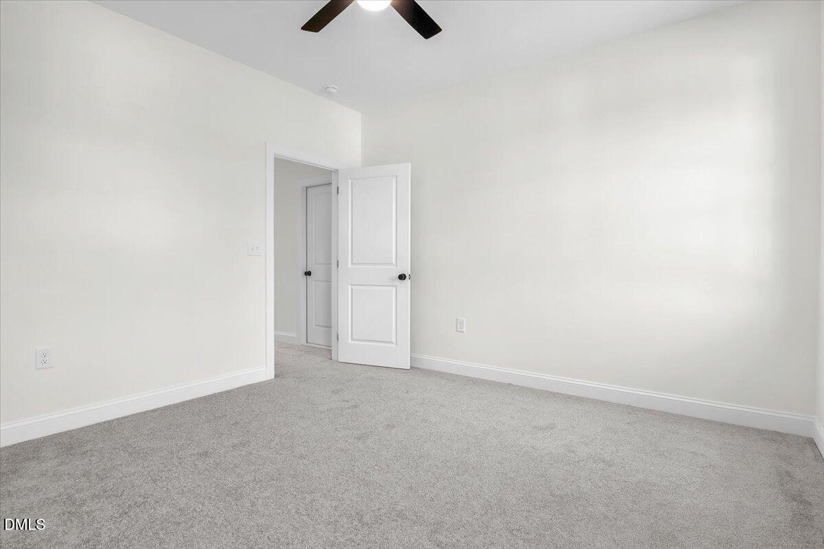 12845 Mallard Rock Road Zebulon, NC 27597 - Photo 55 of 63 an empty room with chandelier fan