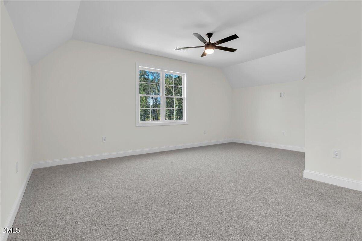 12845 Mallard Rock Road Zebulon, NC 27597 - Photo 60 of 63 an empty room with windows and fan