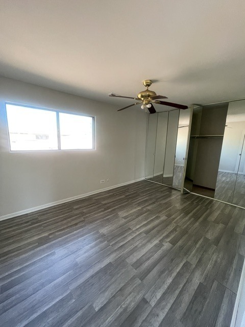1590 Perry Court, Unit A Aurora, IL 60505 - Photo 13 of 17 an empty room with wooden floor and windows