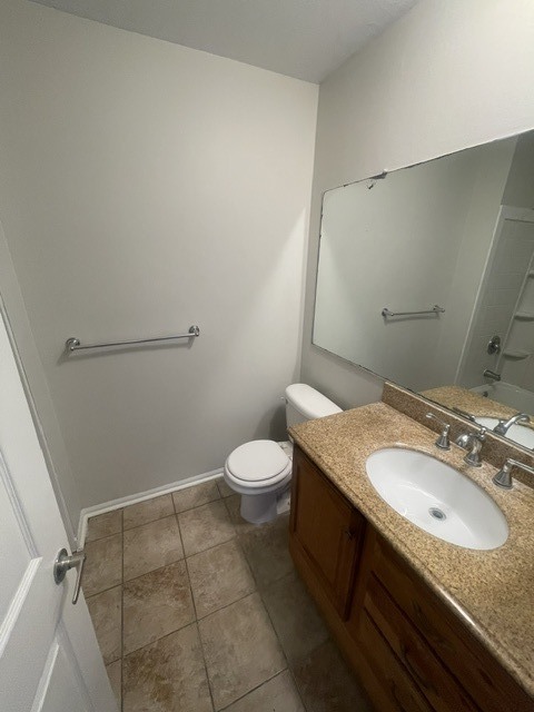 1590 Perry Court, Unit A Aurora, IL 60505 - Photo 14 of 17 a bathroom with a granite countertop sink a toilet and a mirror
