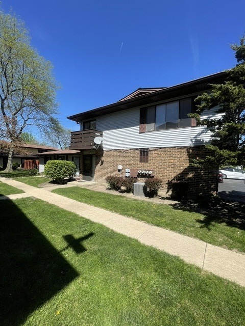 1590 Perry Court, Unit A Aurora, IL 60505 - Photo 2 of 17 a front view of a house with a yard