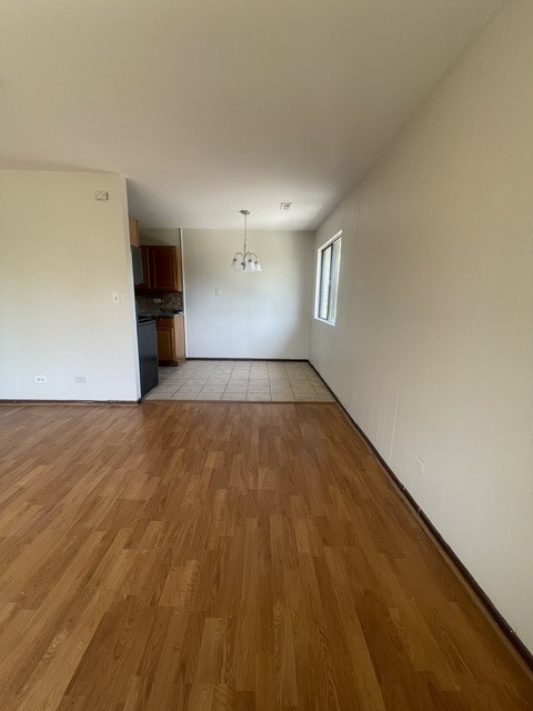 1590 Perry Court, Unit A Aurora, IL 60505 - Photo 7 of 17 a view of empty room with wooden floor