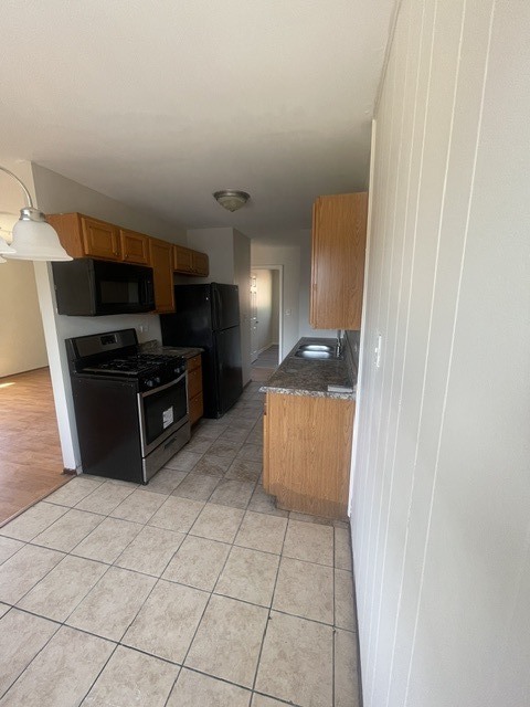 1590 Perry Court, Unit A Aurora, IL 60505 - Photo 8 of 17 a kitchen with stainless steel appliances a refrigerator and a sink