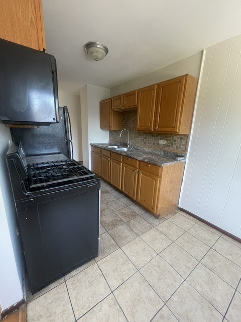 1590 Perry Court, Unit A Aurora, IL 60505 - Photo 10 of 17 a kitchen with granite countertop a stove and a sink