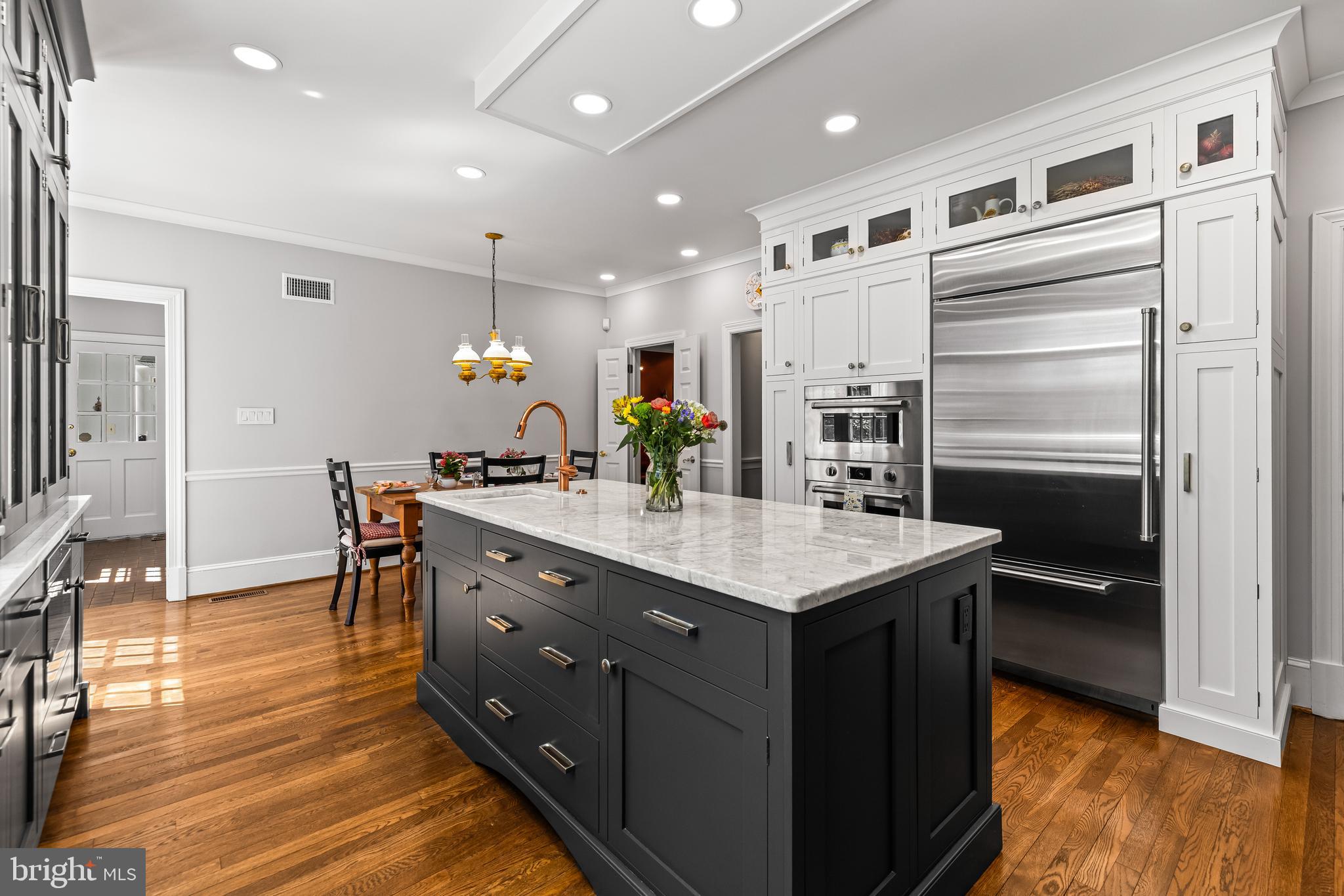 901 Chestnut Ridge Drive Lutherville-Timonium, MD 21093 - Photo 28 of 138 a kitchen with stainless steel appliances granite countertop a table chairs and a refrigerator