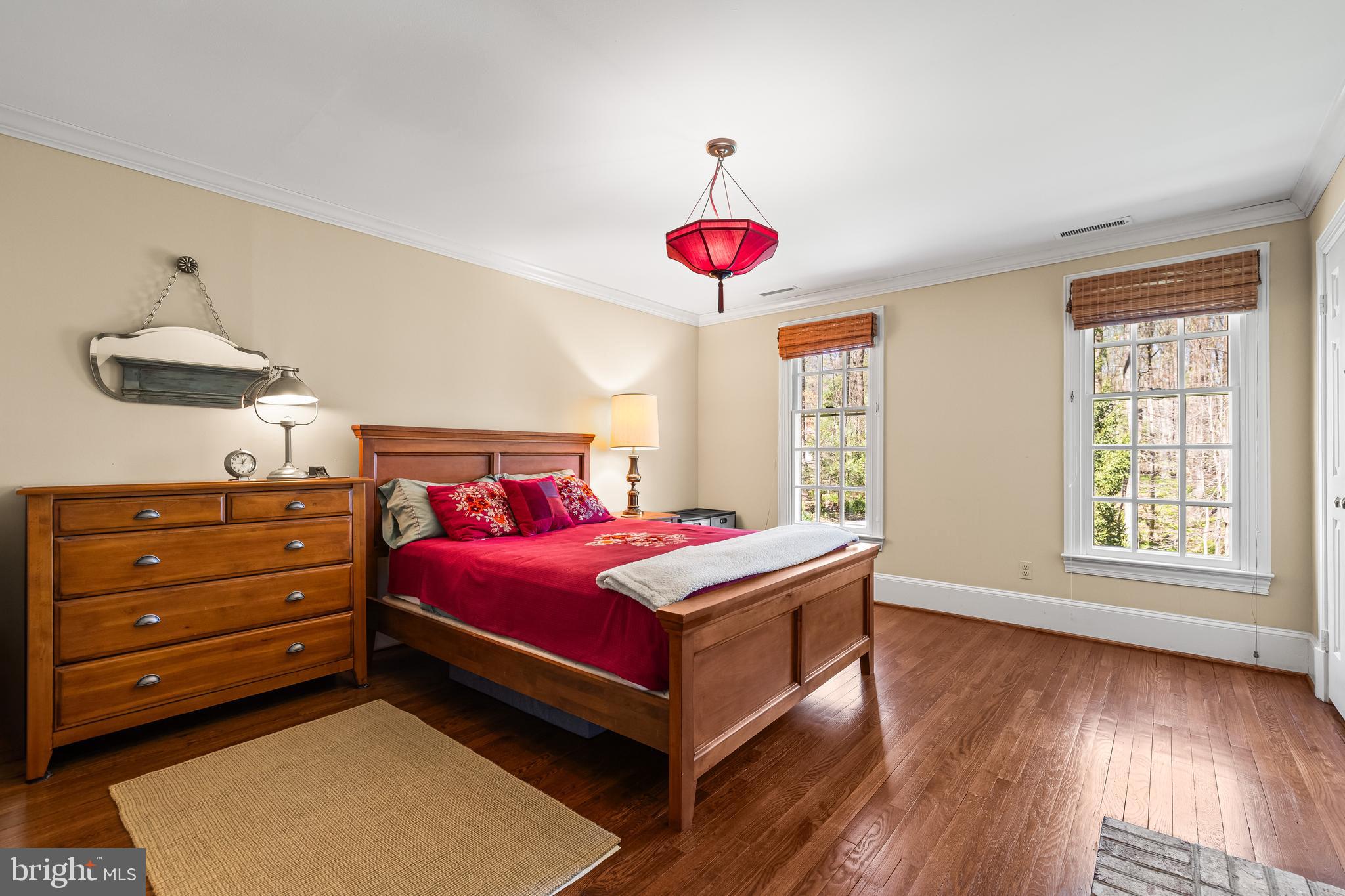 901 Chestnut Ridge Drive Lutherville-Timonium, MD 21093 - Photo 52 of 138 a bedroom with a bed and a chandelier