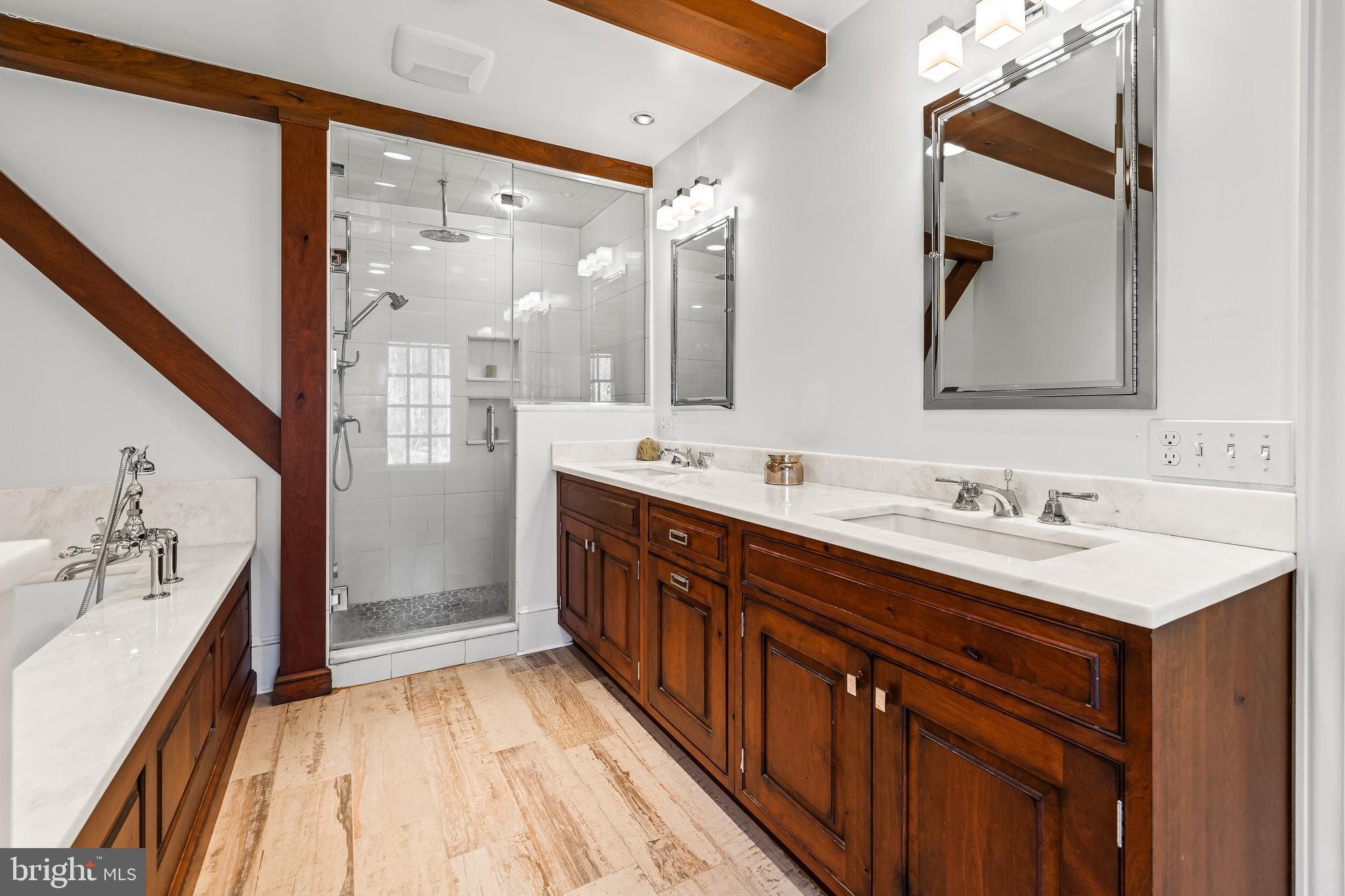 901 Chestnut Ridge Drive Lutherville-Timonium, MD 21093 - Photo 75 of 138 a bathroom with a double vanity sink a mirror and a shower