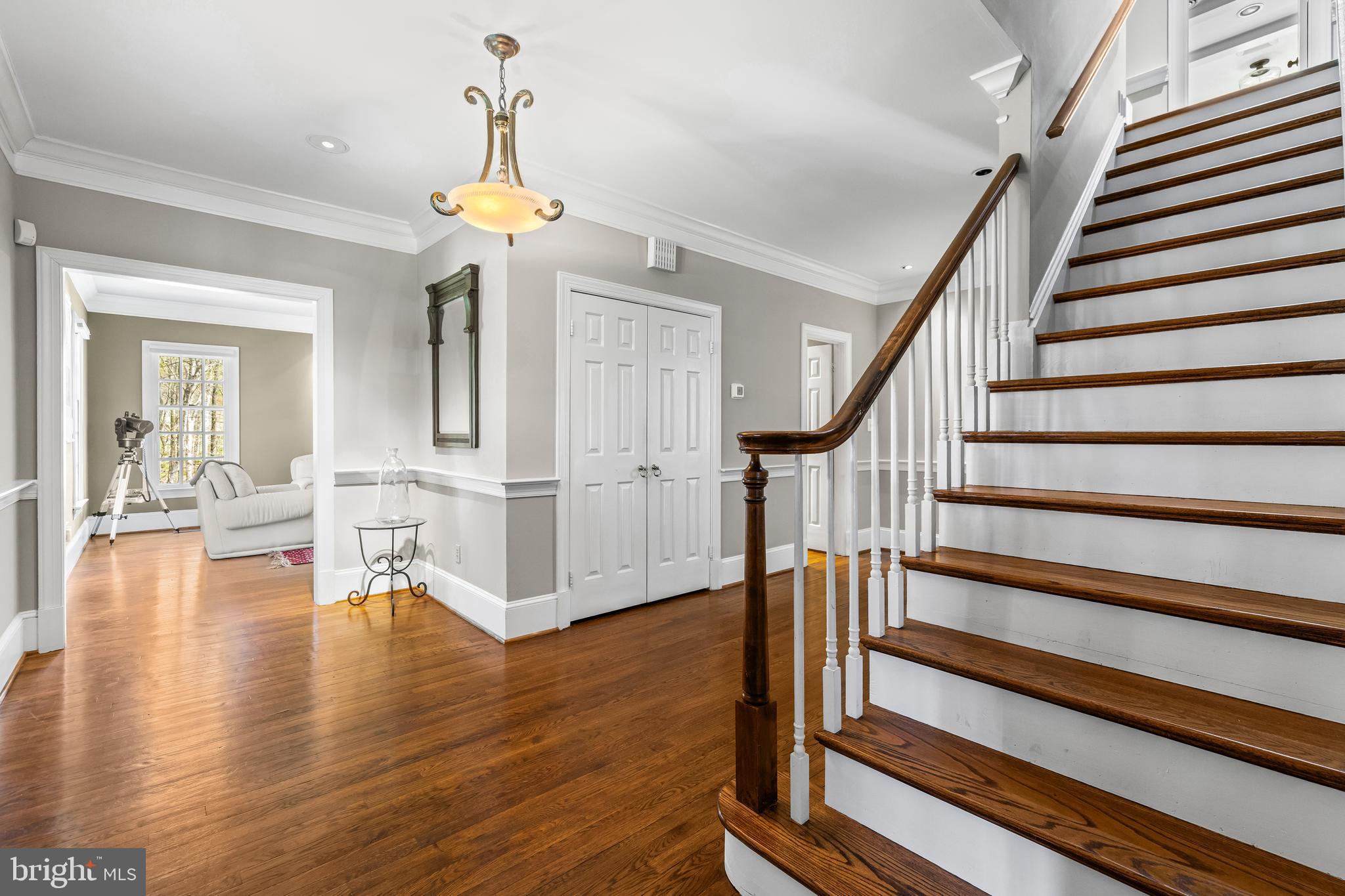 901 Chestnut Ridge Drive Lutherville-Timonium, MD 21093 - Photo 9 of 138 a view of a livingroom with wooden floor and a chandelier