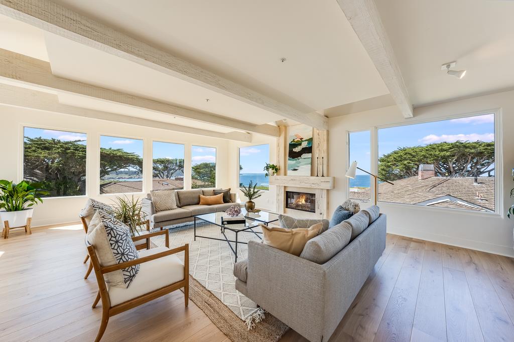 2863 Cuesta Way Carmel, CA 93923 - Photo 11 of 59 a living room with furniture fireplace and a large window