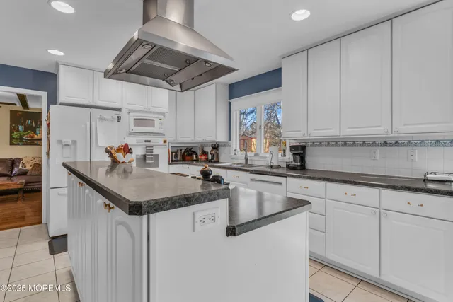 a kitchen with stainless steel appliances granite countertop a sink a stove and cabinets