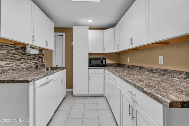 a kitchen with granite countertop a sink and a stove