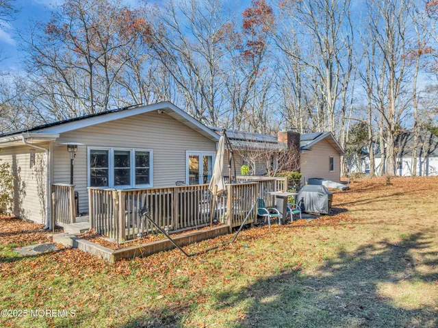 a view of a patio with couches table and chairs and wooden floor