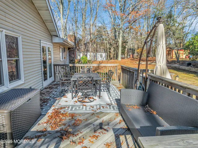 a view of a chair and table on the deck