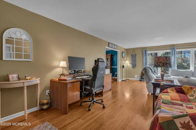 a view of a workspace with furniture and a window