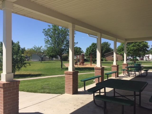 424 32 Road, Unit 148 Clifton, CO 81520 - Photo 11 of 26 a view of a patio with table and chairs potted plants and a palm tree