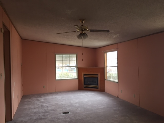 424 32 Road, Unit 148 Clifton, CO 81520 - Photo 14 of 26 an empty room with windows and fireplace