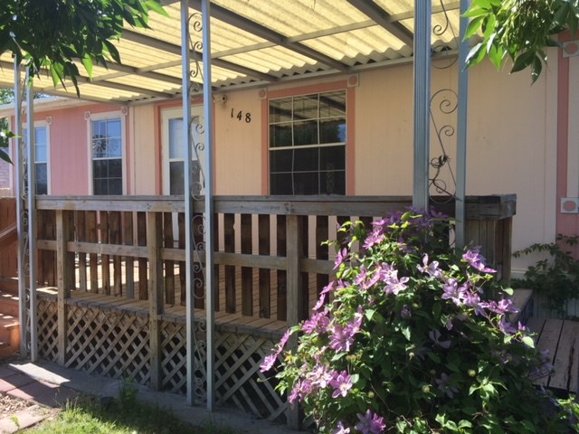 424 32 Road, Unit 148 Clifton, CO 81520 - Photo 3 of 26 a bunch of flowers in front of a house