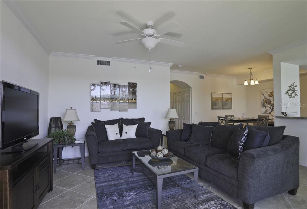 Undisclosed Address Lakewood Ranch, FL 34211 - Photo 17 of 28 a living room with furniture and a flat screen tv