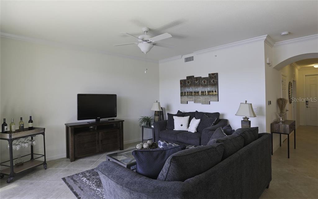 Undisclosed Address Lakewood Ranch, FL 34211 - Photo 18 of 28 a living room with furniture and a flat screen tv
