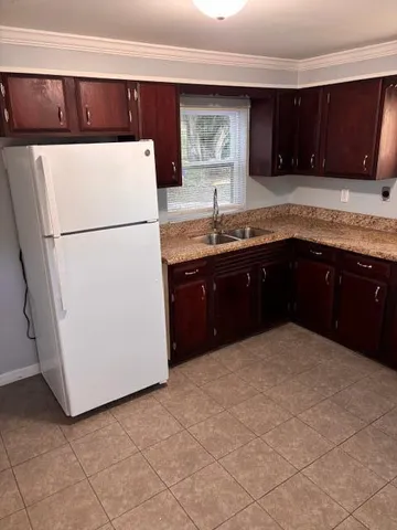 a kitchen with a refrigerator and a sink