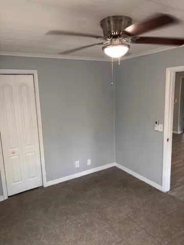 a view of a small space with a chandelier fan