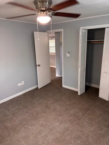 a view of a big room with closet and wooden door