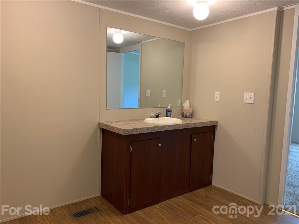 169 Mosley Road Blacksburg, SC 29702 - Photo 12 of 20 a bathroom with a sink and a mirror