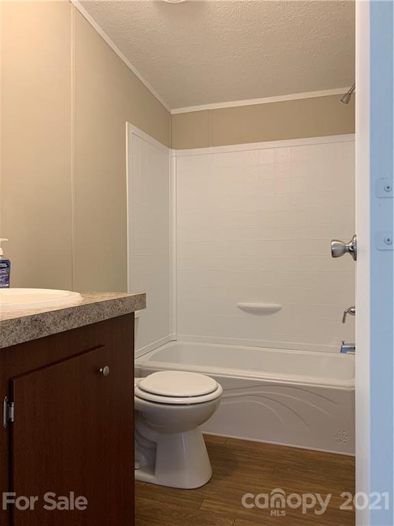 169 Mosley Road Blacksburg, SC 29702 - Photo 16 of 20 a bathroom with a granite countertop toilet and a shower