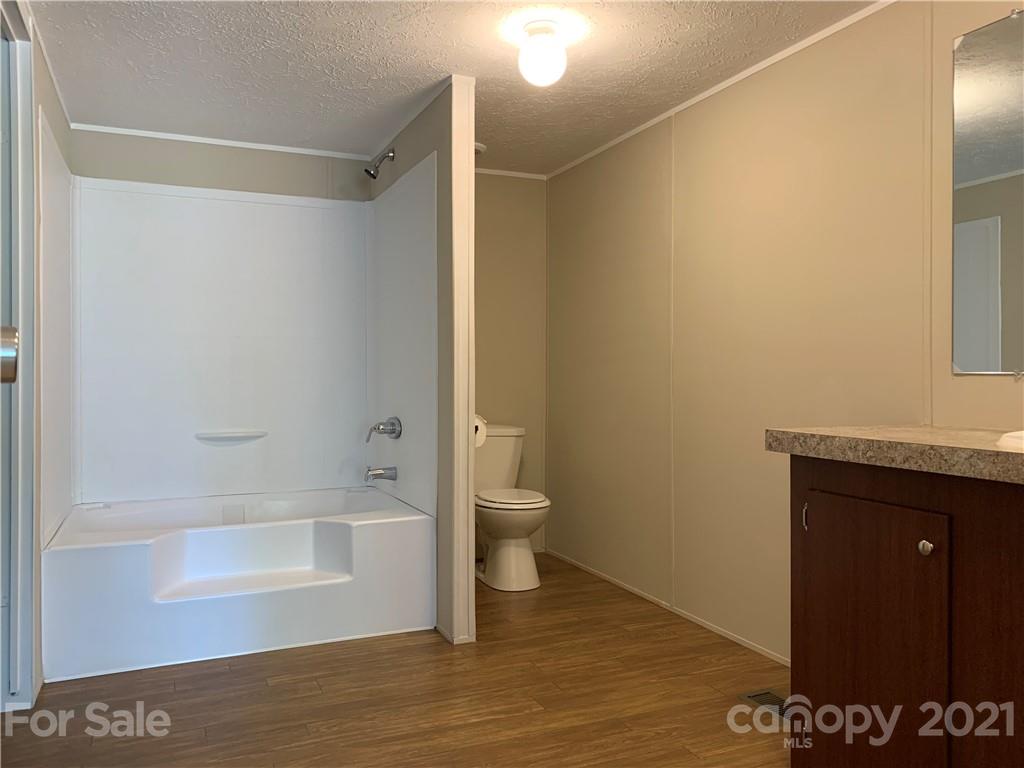 169 Mosley Road Blacksburg, SC 29702 - Photo 17 of 20 a bathroom with a granite countertop bathtub shower and toilet