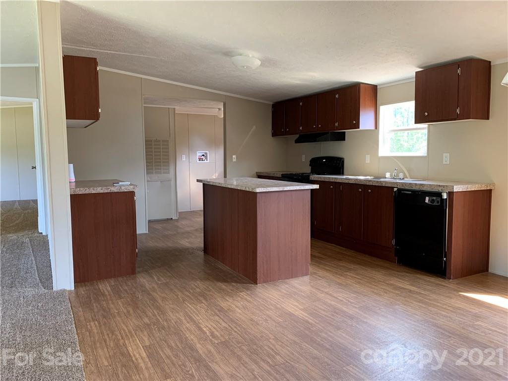 169 Mosley Road Blacksburg, SC 29702 - Photo 7 of 20 a kitchen with stainless steel appliances granite countertop a stove top oven a sink dishwasher and a refrigerator with wooden floor