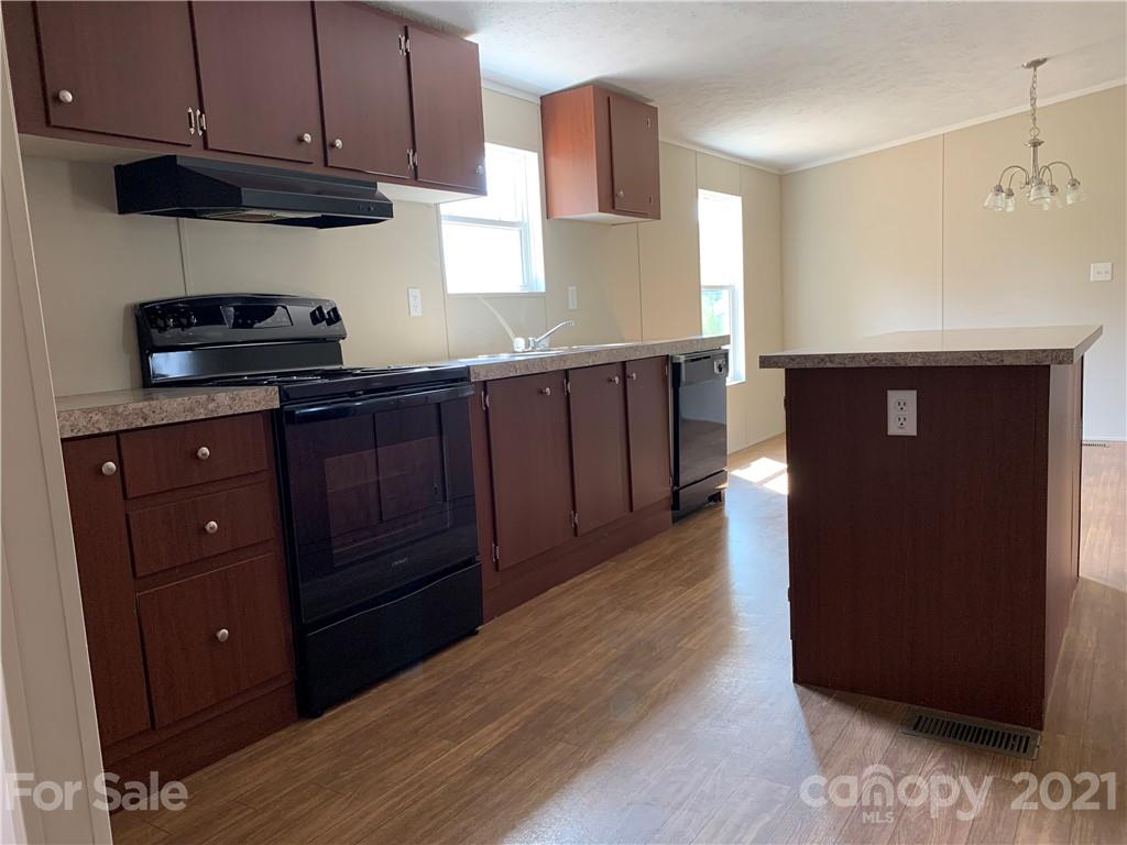 169 Mosley Road Blacksburg, SC 29702 - Photo 8 of 20 a kitchen with stainless steel appliances granite countertop wooden cabinets a stove a sink and a hard wood floors