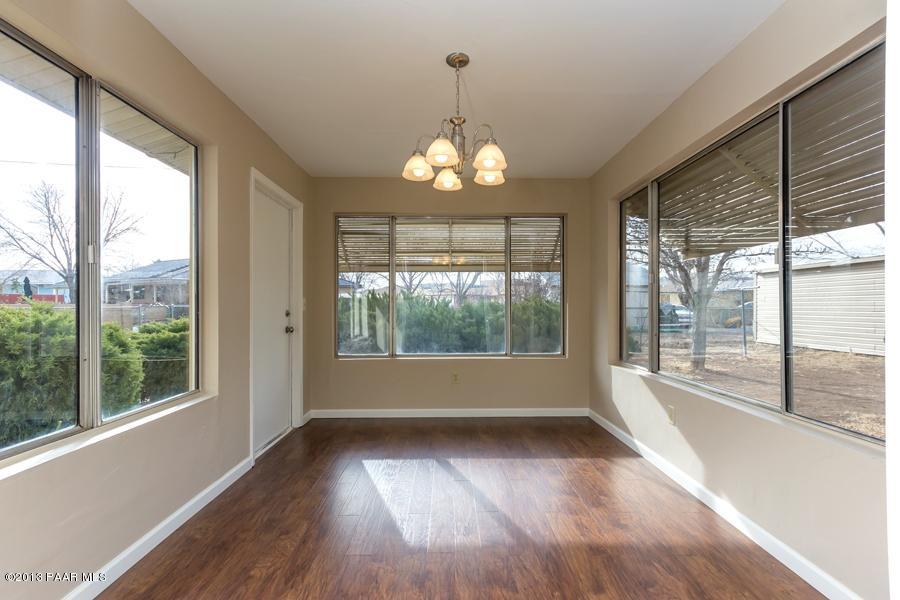 8049 East Barbara Road Prescott Valley, AZ 86314 - Photo 13 of 23 an empty room with wooden floor and windows