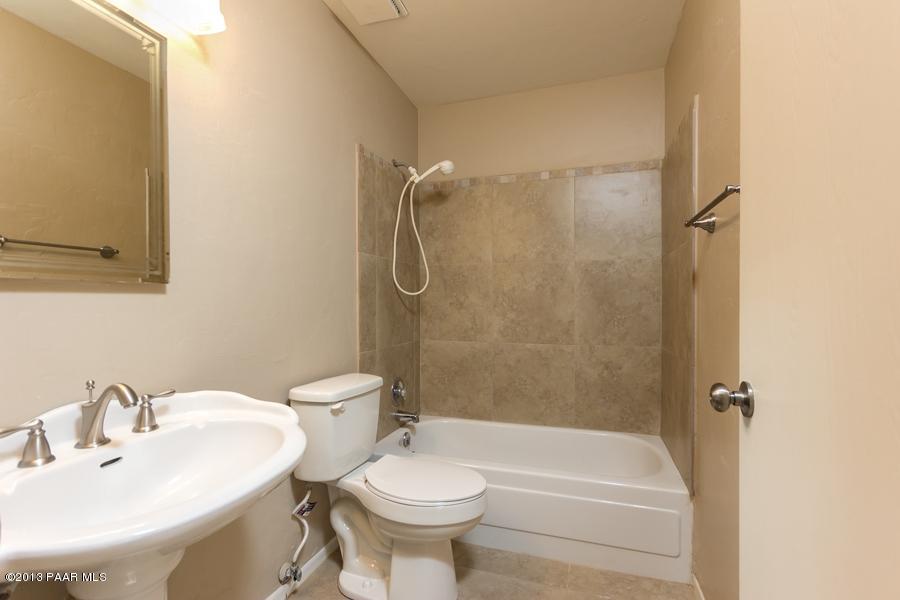 8049 East Barbara Road Prescott Valley, AZ 86314 - Photo 14 of 23 a bathroom with a sink toilet and shower
