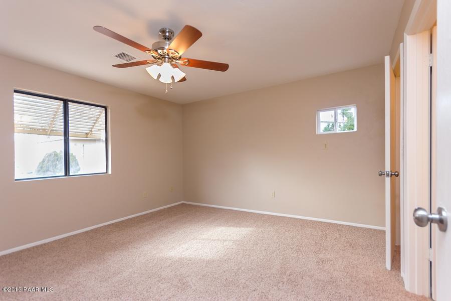 8049 East Barbara Road Prescott Valley, AZ 86314 - Photo 16 of 23 an empty room with windows and fan