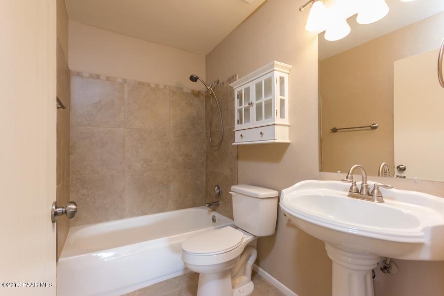 8049 East Barbara Road Prescott Valley, AZ 86314 - Photo 18 of 23 a bathroom with a sink toilet and shower