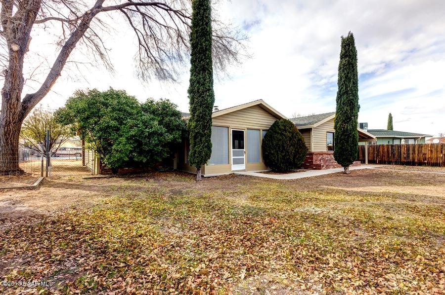 8049 East Barbara Road Prescott Valley, AZ 86314 - Photo 2 of 23 a view of a house with backyard and a tree