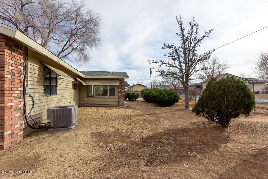 8049 East Barbara Road Prescott Valley, AZ 86314 - Photo 23 of 23 a view of a house with a backyard and a tree