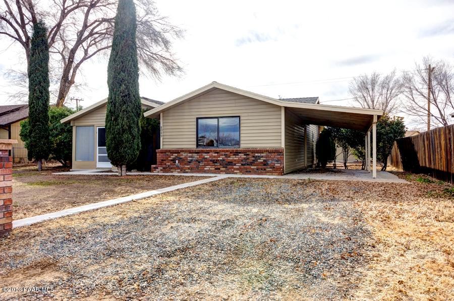 8049 East Barbara Road Prescott Valley, AZ 86314 - Photo 3 of 23 a view of a house with a yard and large tree