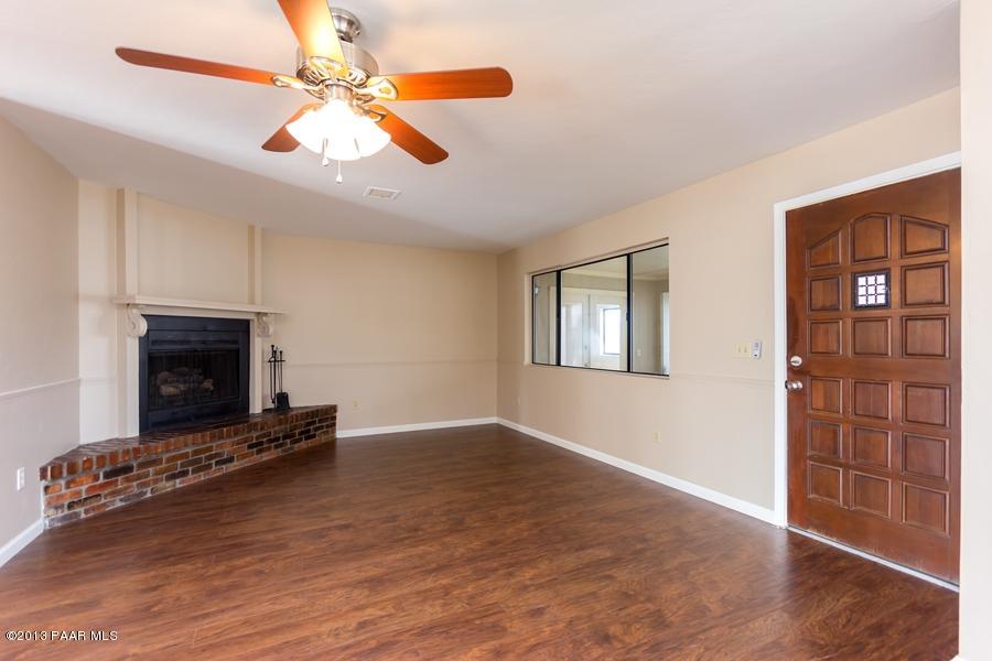 8049 East Barbara Road Prescott Valley, AZ 86314 - Photo 5 of 23 an empty room with windows and fireplace