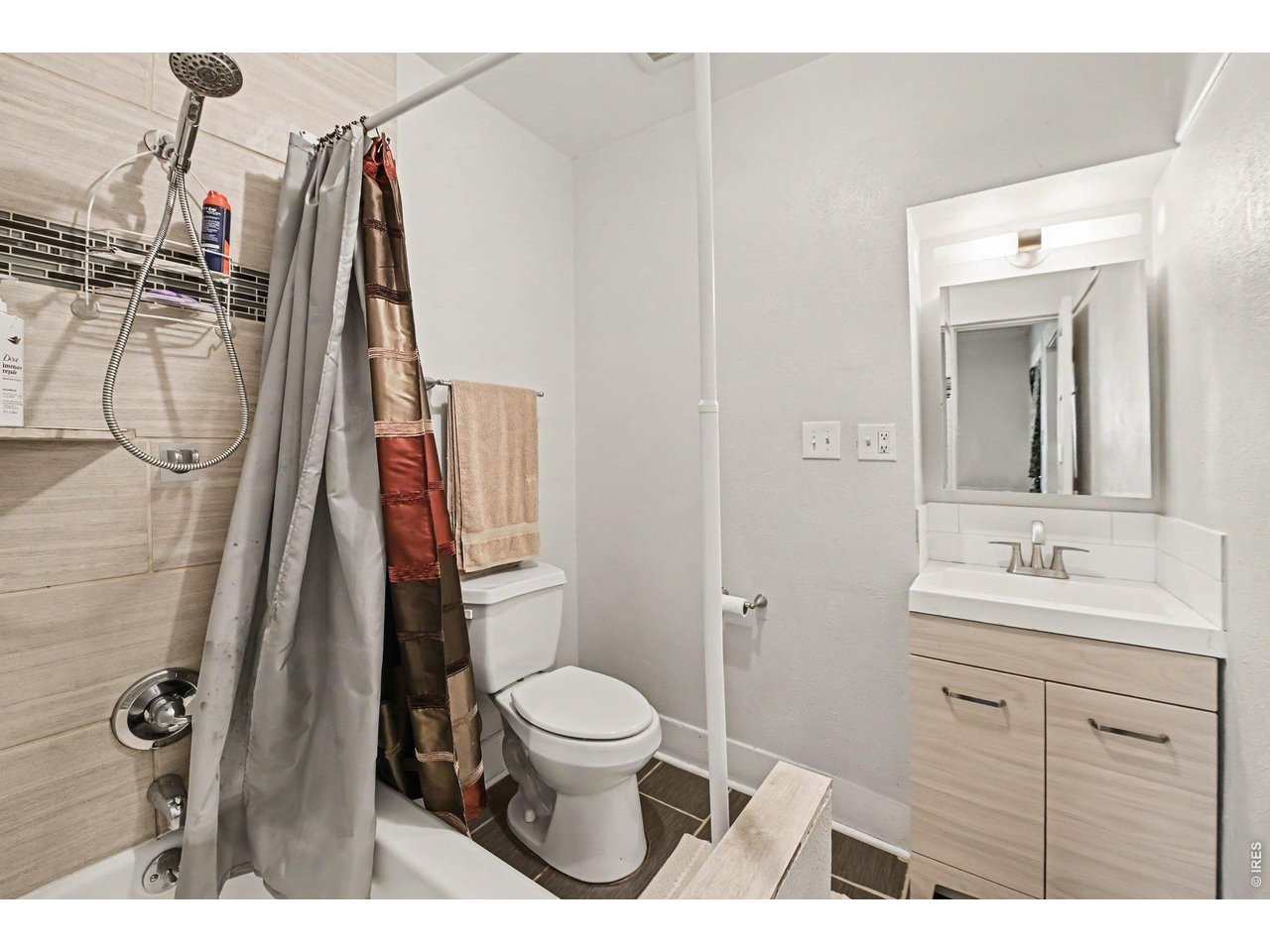 427 9th Street Greeley, CO 80631 - Photo 16 of 22 a bathroom with a toilet sink and mirror