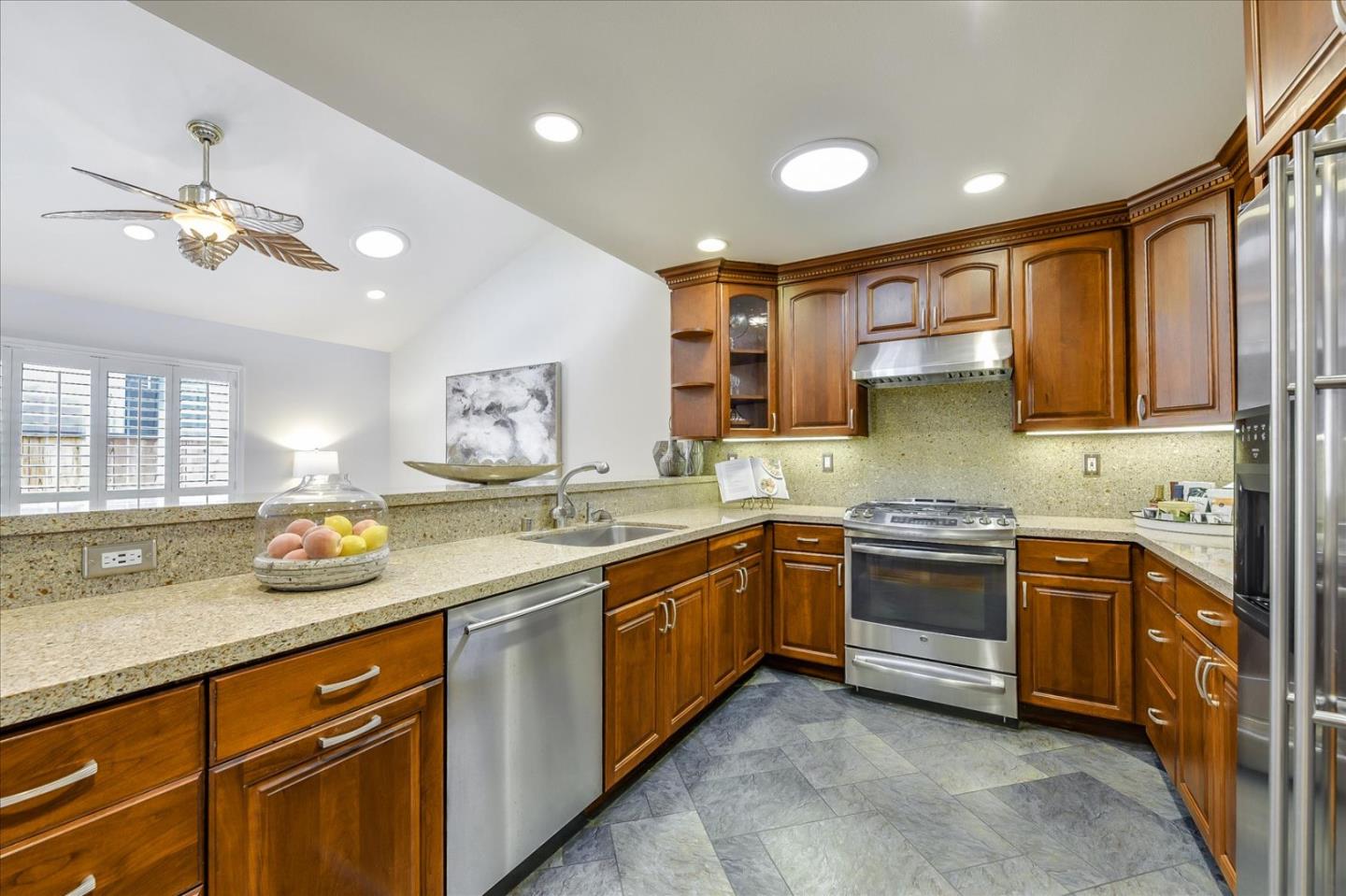 828 Linda Mar Boulevard Pacifica, CA 94044 - Photo 16 of 44 a kitchen with stainless steel appliances granite countertop a sink and stove