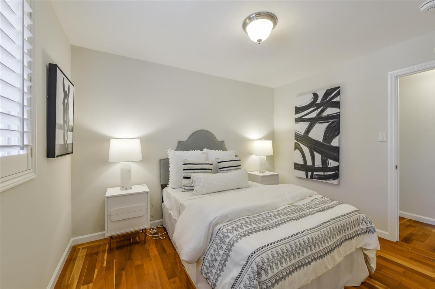 828 Linda Mar Boulevard Pacifica, CA 94044 - Photo 22 of 44 a bedroom with a bed and a painting on the wall