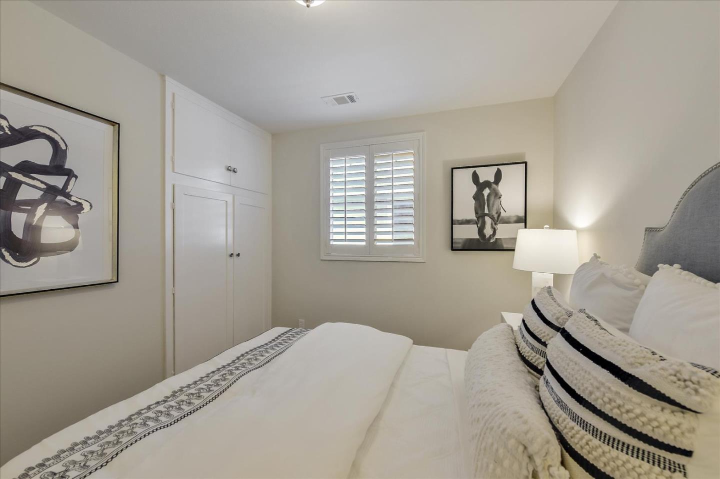 828 Linda Mar Boulevard Pacifica, CA 94044 - Photo 24 of 44 a bedroom with a bed and cabinets