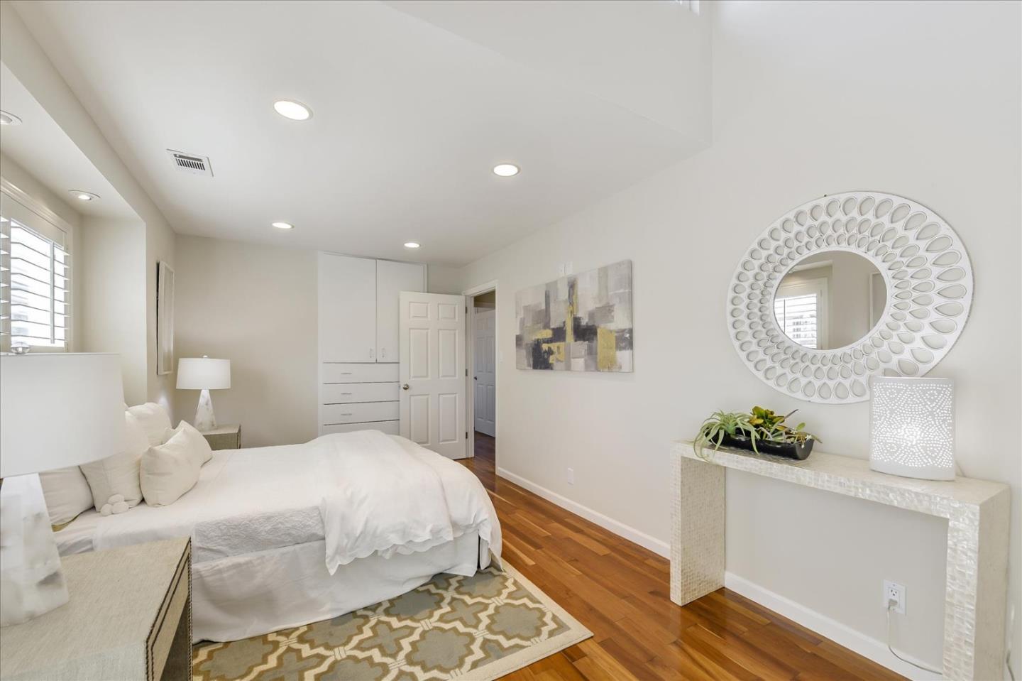 828 Linda Mar Boulevard Pacifica, CA 94044 - Photo 31 of 44 a spacious bedroom with a bed and a dresser