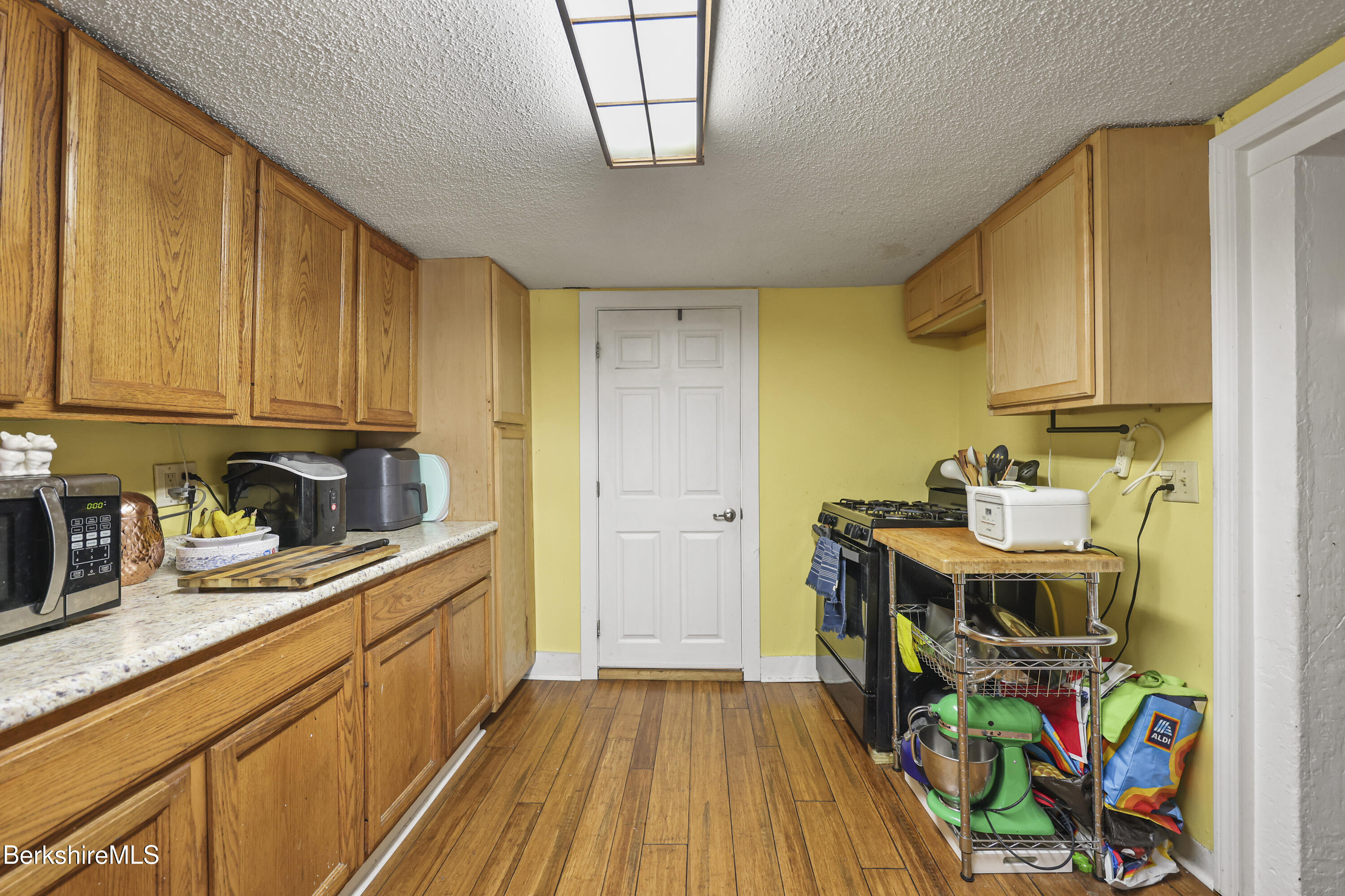 1 Maple Street Hinsdale, MA 01235 - Photo 13 of 17 a view of a kitchen with fridge and wooden floor