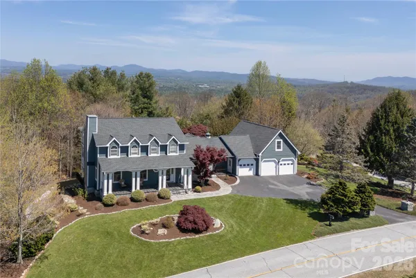 a front view of a house with a big yard