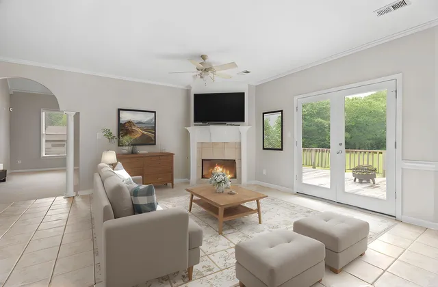 a living room with furniture a flat screen tv and a fireplace