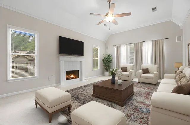 a view of an empty room with a fireplace and a window